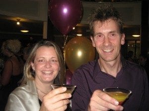 Woman and man celebrate with cocktails