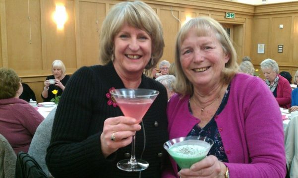 2 women smiling with cocktails