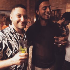 2 young men drinking cocktails