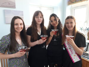 4 girls with red cocktails at home